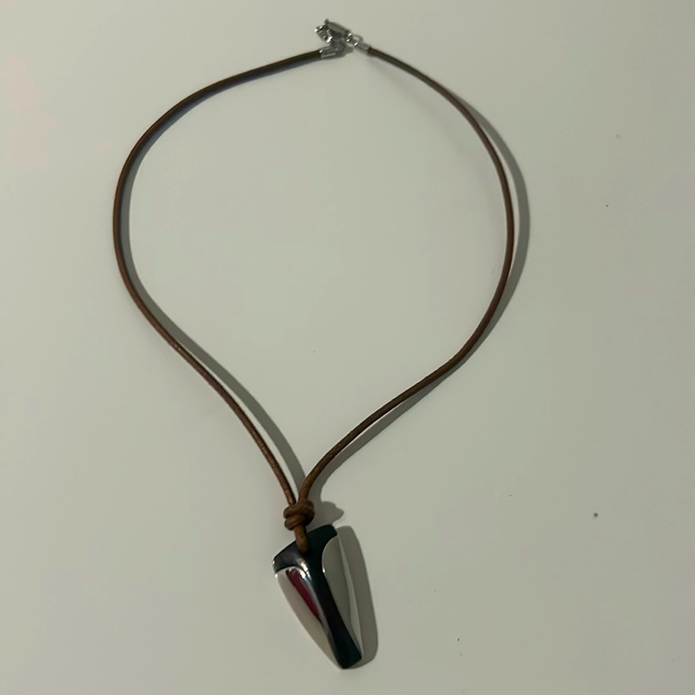 Fossil necklace leather cord and a black and silver pendant